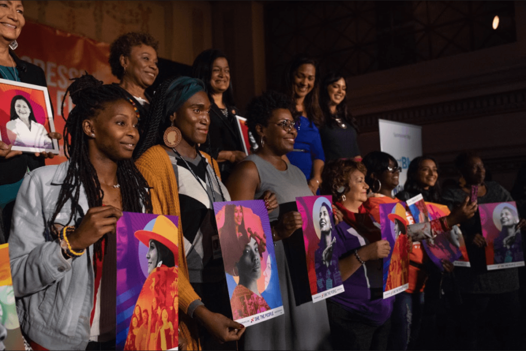 A powerful group of women of color—including congresswomen and representatives from Transgender Law Center, We Act for Environmental Justice, Service Employees International Union, and KC Tenants--take the stage at a She the People event.
