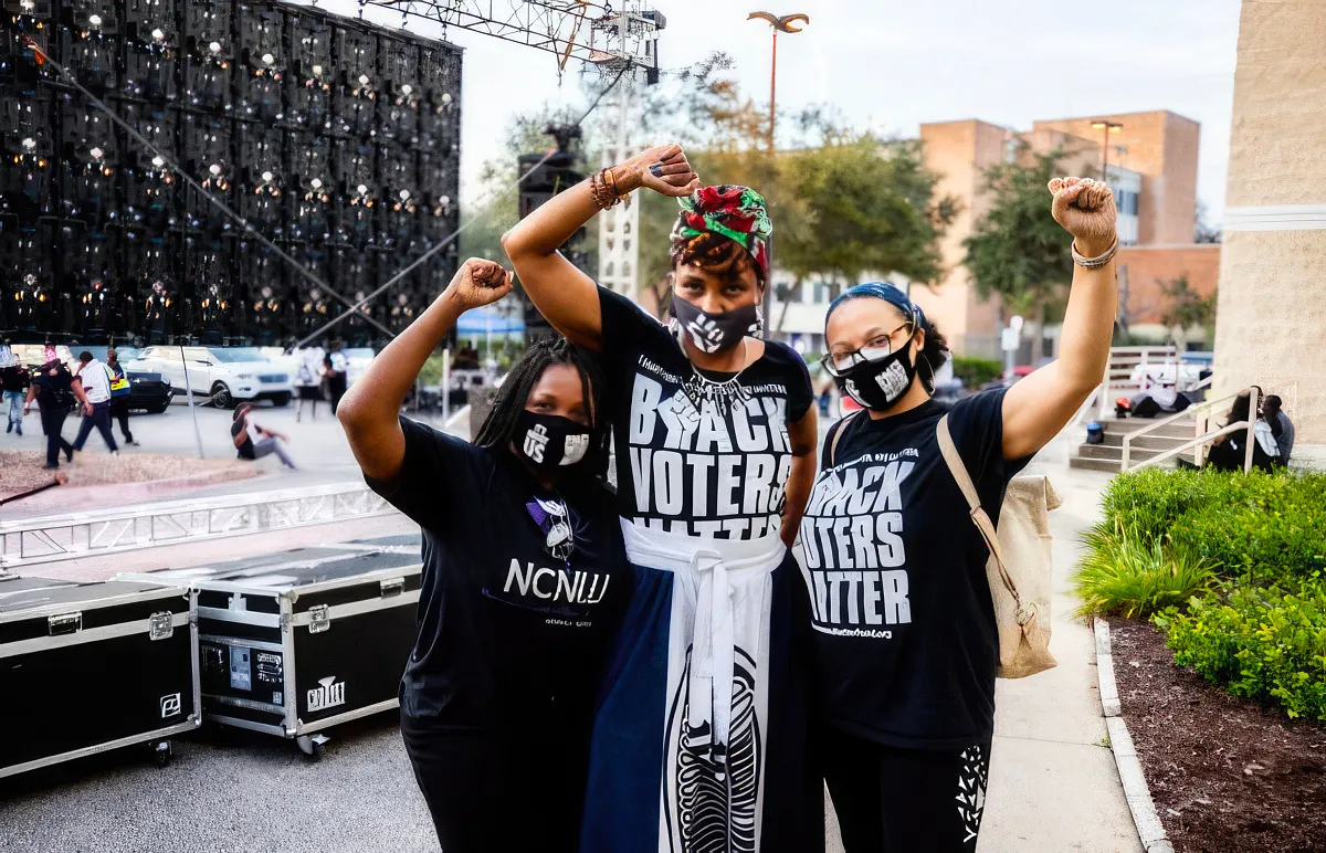 3 black women holding up fists
