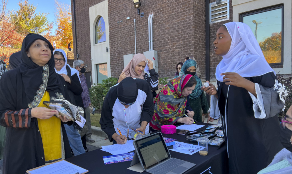 A Black Muslim community organizer with the Georgia Muslim Voters Project, a Healthy Democracy Fund Grantee, helping people register to vote.