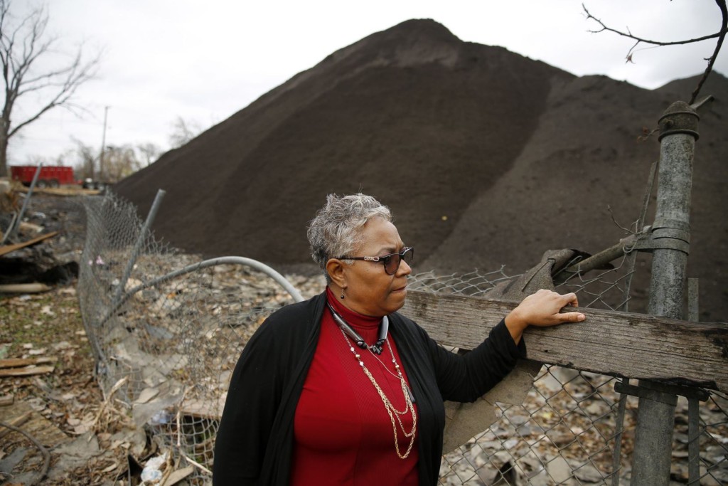 Marsha Jackson, co-chair of Southern Sector Rising, standing in front of a polluted site. (Photo © Dallas Morning News)