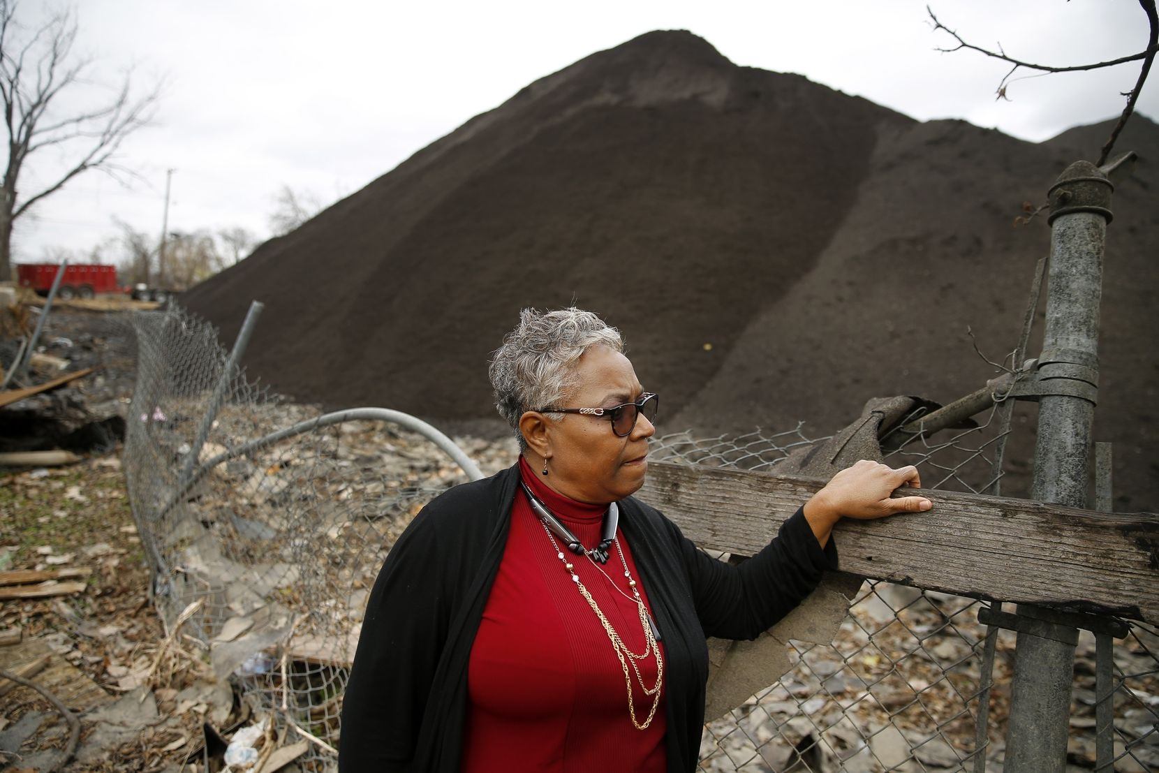 Marsha Jackson, co-chair of Southern Sector Rising, standing in front of a polluted site. (Photo © Dallas Morning News)