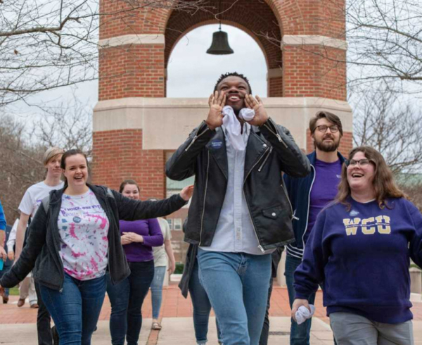 A young Black student joyfully shouting into the air surrounded with his classmates who are smiling. Photo credit: Vote Early Day, a fiscally sponsored project of Tides