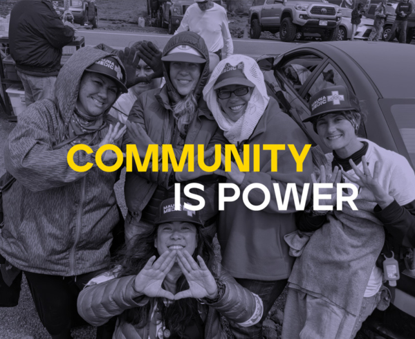 Headline: Community is Power. Image of medical workers smiling and displaying triangle hand signs