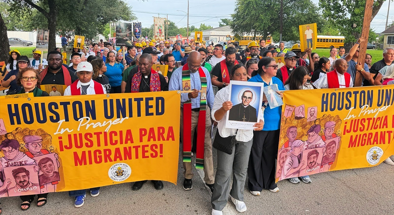 Black and Latine faith leaders and community members march together in Houston behind banners reading "Houston United in Prayer" and "¡Justicia para migrantes!