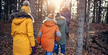 A family on an autumn hike through the woods.