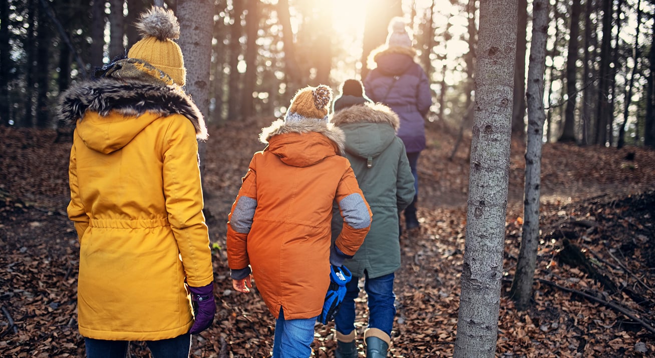 A family on an autumn hike through the woods.