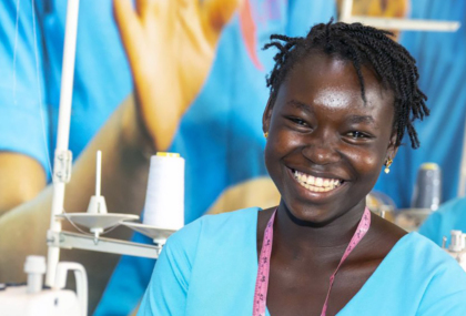 A young Black woman at a sewing station.