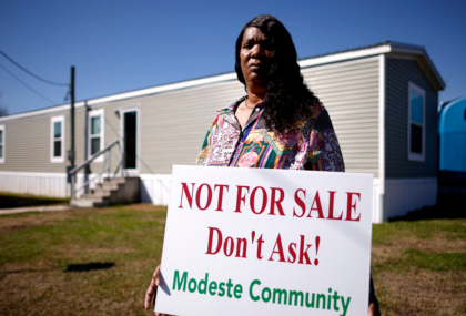 Twila Collins, a Modeste community member in Ascension Parish, Louisiana, holds a sign that reads “Not for Sale. Don’t Ask! – Modeste Community.”